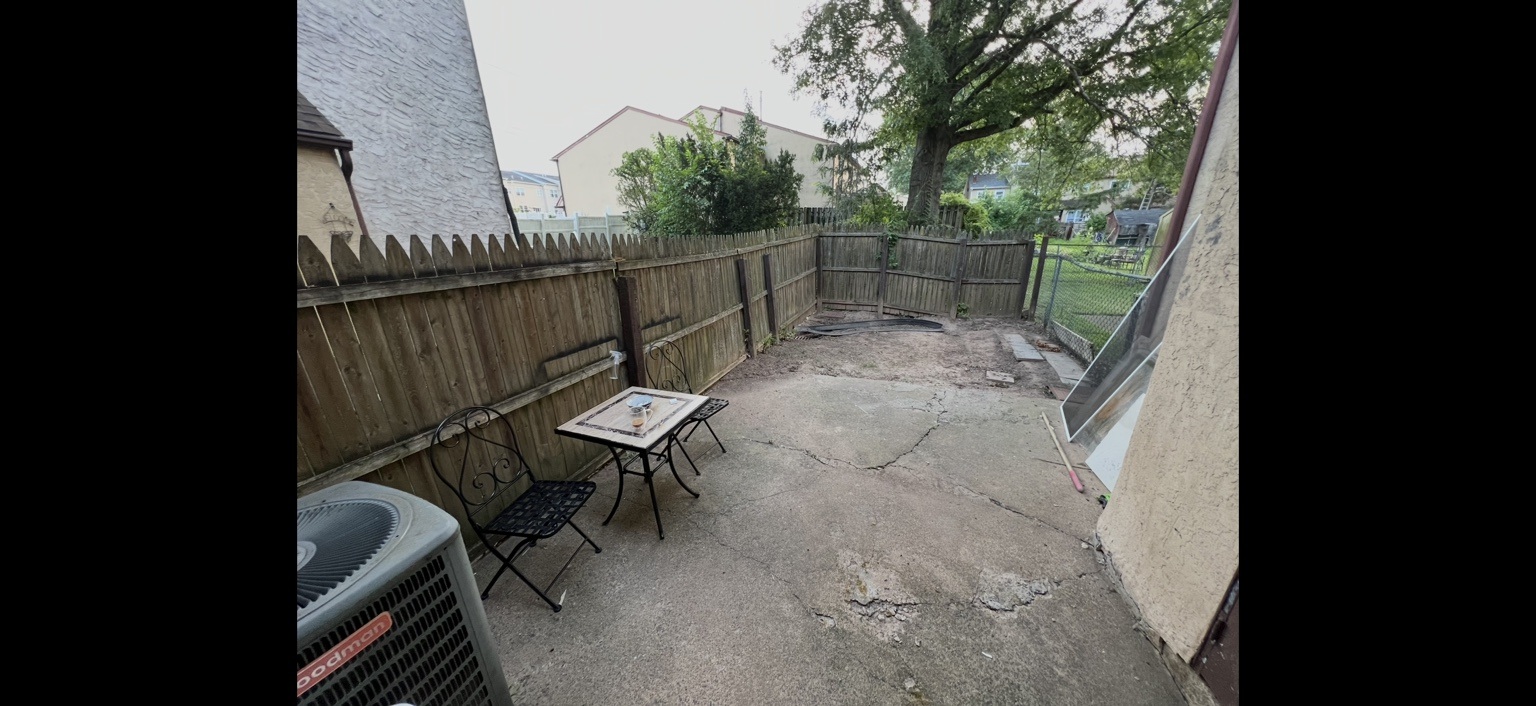 Backyard patio and fence before remodeling